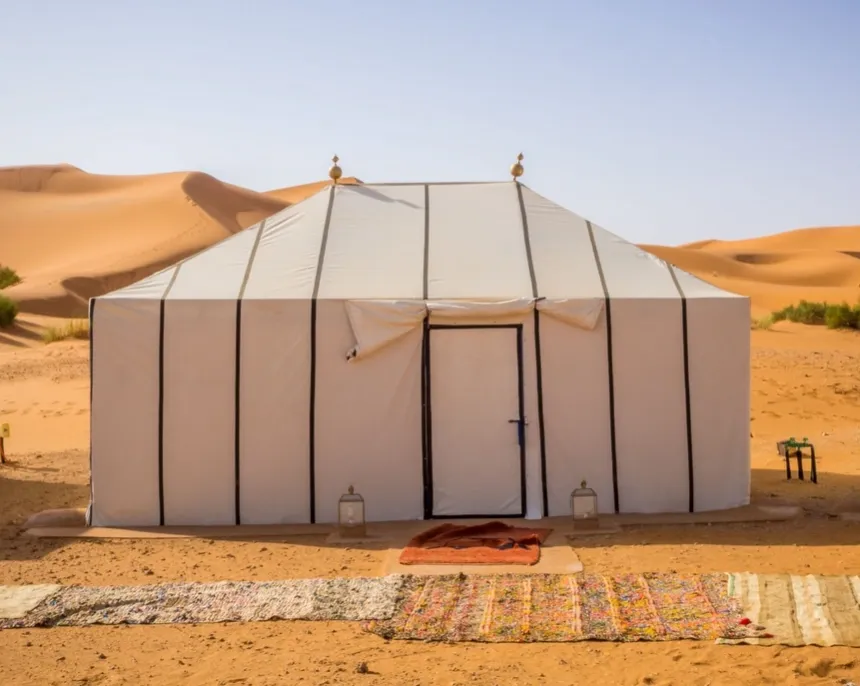 Traditional Bedouin tent camp setup in UAE desert with woven fabric and majlis seating area