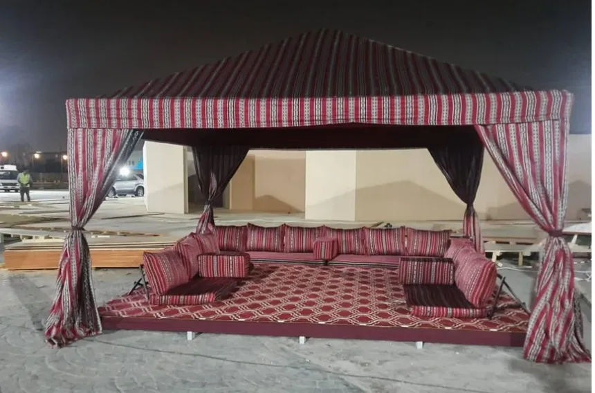 Bedouin tent installation in a Dubai villa garden with traditional poles and canvas